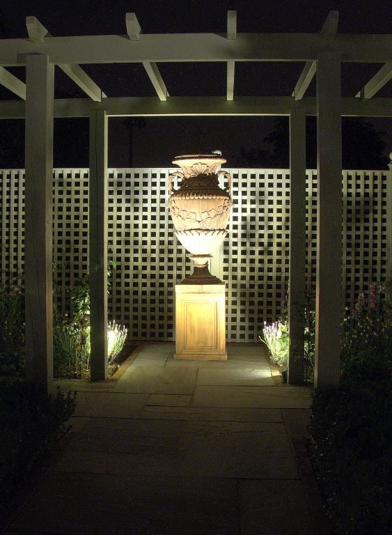 Urn with pergola, trellis, and lighting